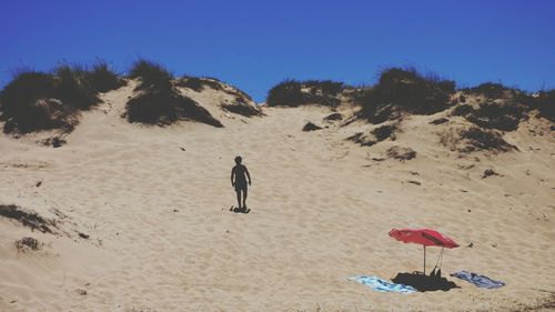 Low angle view of woman walking at beach