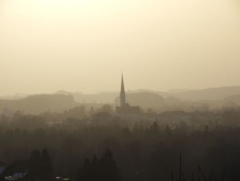 Silhouette of buildings against sky during sunset
