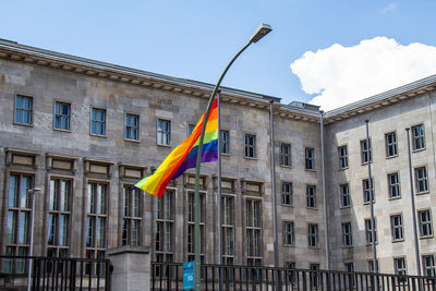 Low angle view of flag against buildings in city