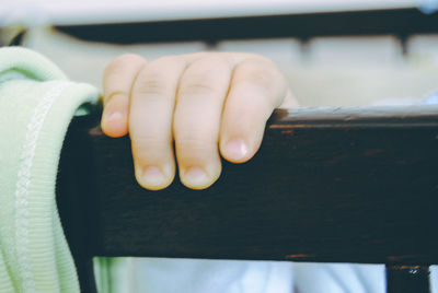 Cropped hand of child in crib