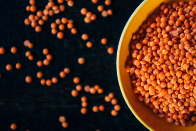 Orange lentils in bowl on table