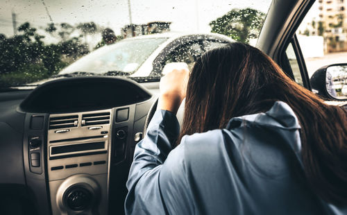 Rear view of woman in car