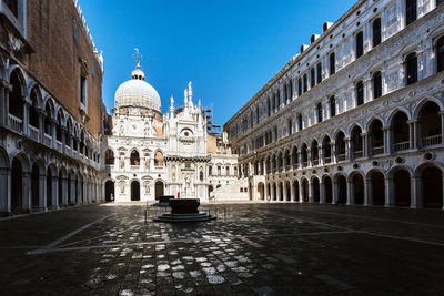 St mark basilica by doges palace against clear blue sky