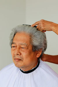 Close-up portrait of man against white background
