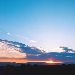 Scenic view of landscape against sky at sunset