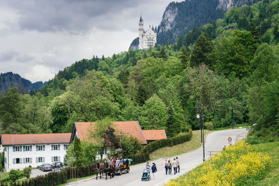 People on mountain against sky