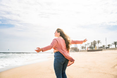 Young woman standing at beach