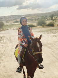 Portrait of man riding horse