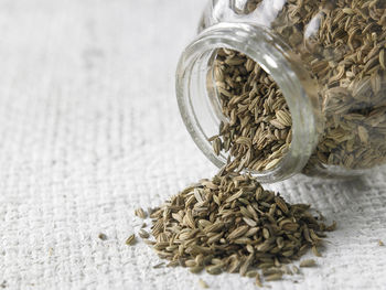 Close-up of cumin seeds in jar on table