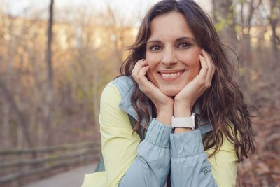 Portrait of young woman sitting on field