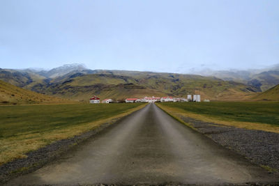 Empty road along countryside landscape