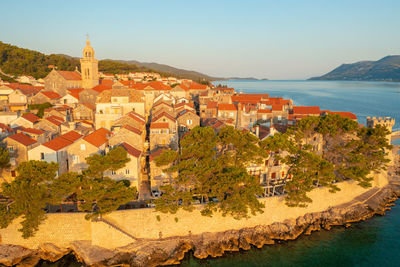 Town by sea against clear sky