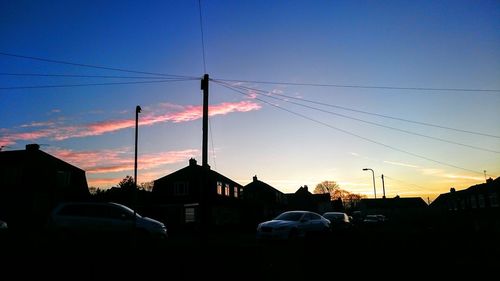 Cars on street at sunset