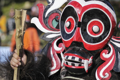 Close-up of person wearing traditional mask