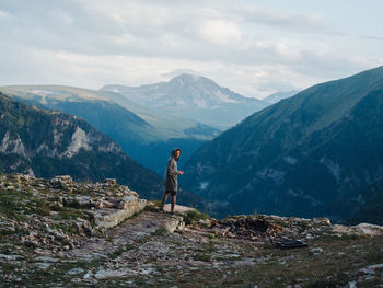 Man standing on mountain against sky