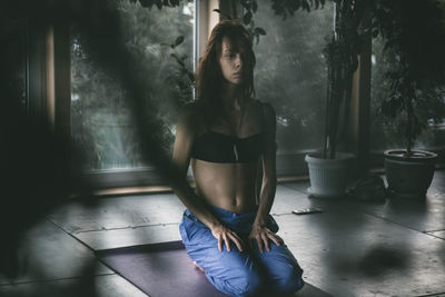 Young woman doing yoga at home