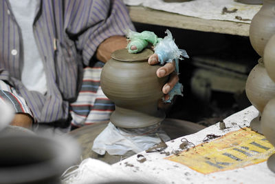 Midsection of man working at workshop