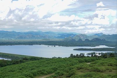 Scenic view of lake and mountains against sky