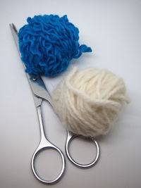 High angle view of wool and scissor on table