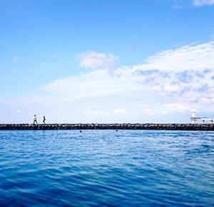 Scenic view of sea against cloudy sky