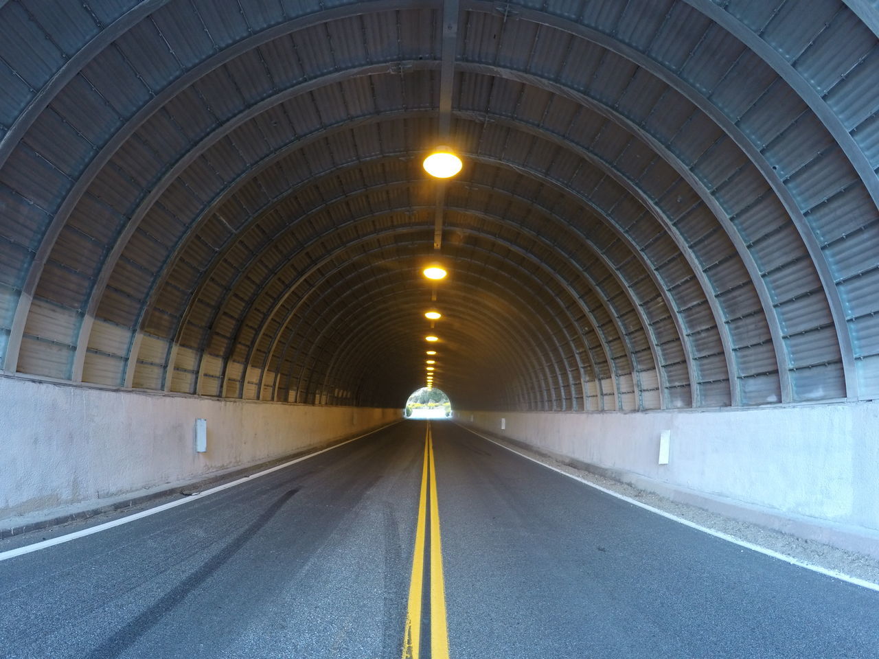 the way forward, diminishing perspective, tunnel, indoors, vanishing point, transportation, ceiling, architecture, arch, built structure, illuminated, empty, long, road, road marking, lighting equipment, light at the end of the tunnel, travel, no people, subway