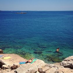 High angle view of woman by sea against clear sky