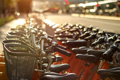 Bicycles parked on road during sunny day