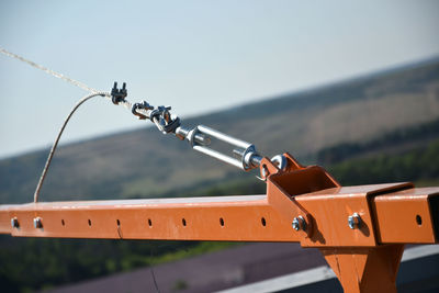 Close-up of metal railing against sky