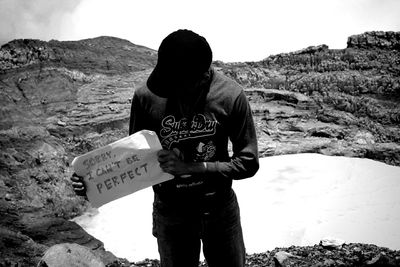 Rear view of man standing on rock