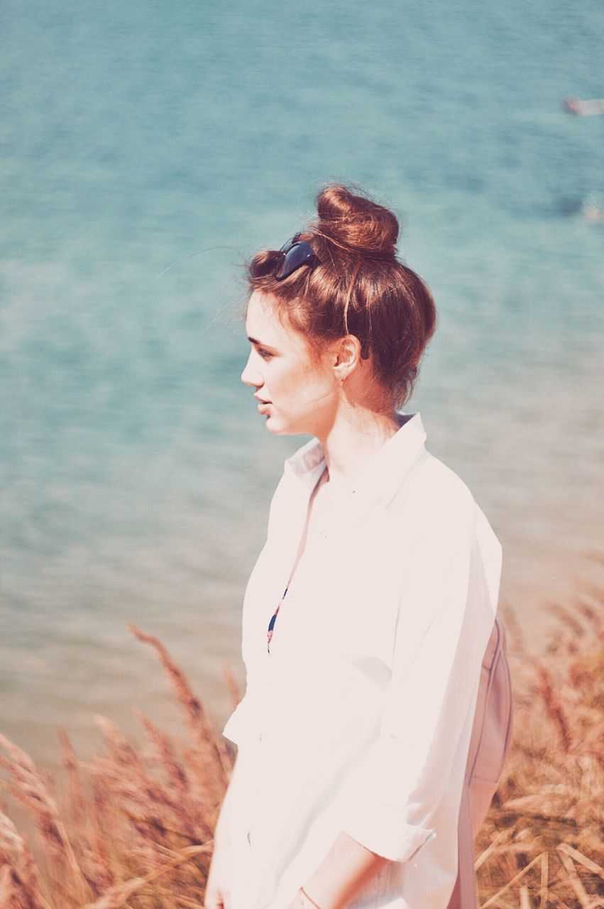 WOMAN STANDING ON BEACH