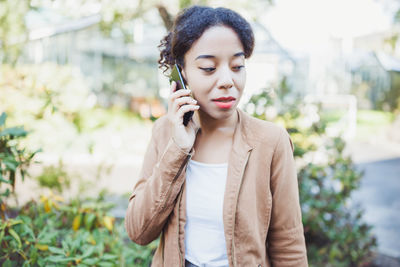 Young multiracial african woman speaking on mobile phone