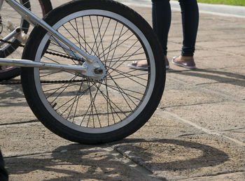 Low section of person with high angle view of tire