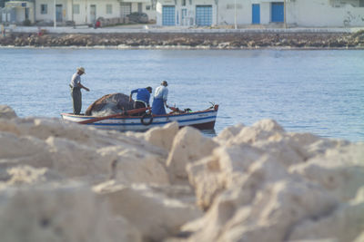 A shot of fishermen on a boat entering harbor