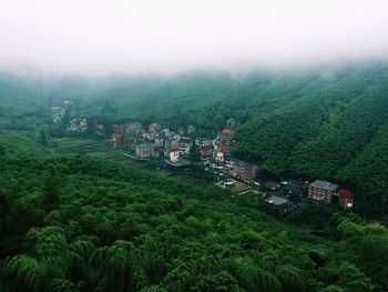 High angle view of green landscape against sky