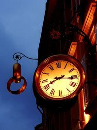 Low angle view of illuminated lamp at night