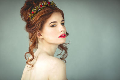 Portrait of beautiful young woman over white background