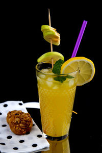 Close-up of drink on table against black background