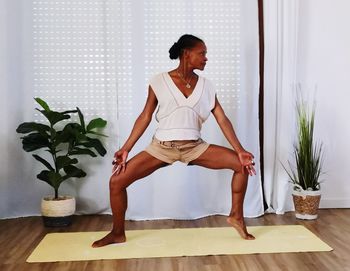 Young woman exercising on floor at home