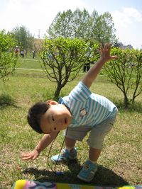 Low angle view of children playing on field