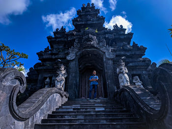 Low angle view of man standing against temple