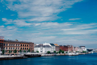 Buildings against cloudy sky