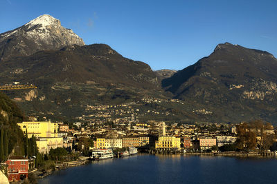 High angle view of townscape by mountains against sky