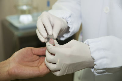 Cropped image of doctor examining patient in hospital