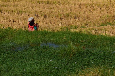 Rear view of woman on field