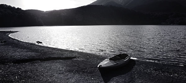 Scenic view of lake by mountain against sky