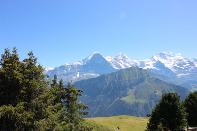 Scenic view of mountains against clear blue sky