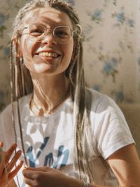 Portrait of young woman with arms crossed