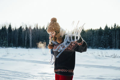 Young woman holding snow