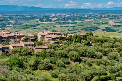 Aerial view of trees and buildings against mountains