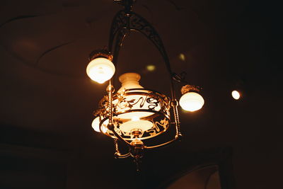 Low angle view of illuminated pendant light hanging from ceiling